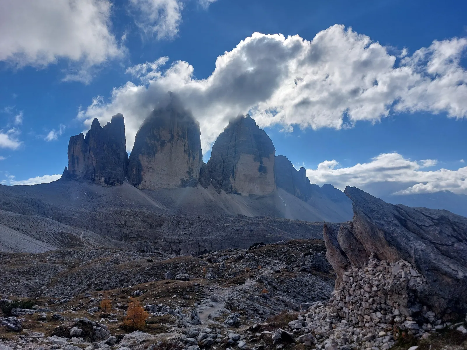 Tre Cime di Lavaredo under a blue sky and fast cloud
