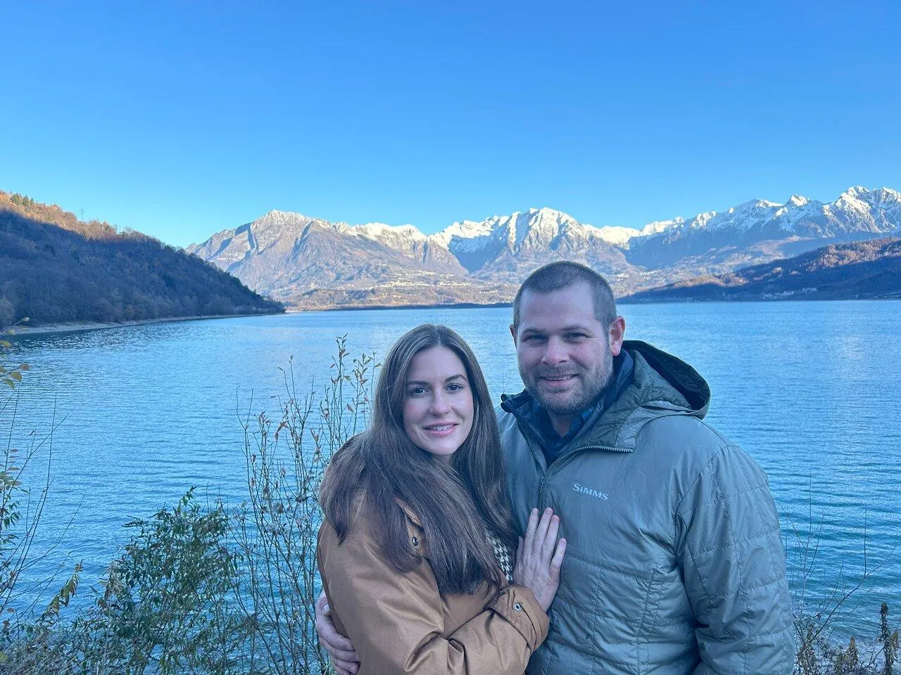 Couple at the Centro Cadore lake on a clear autumn day