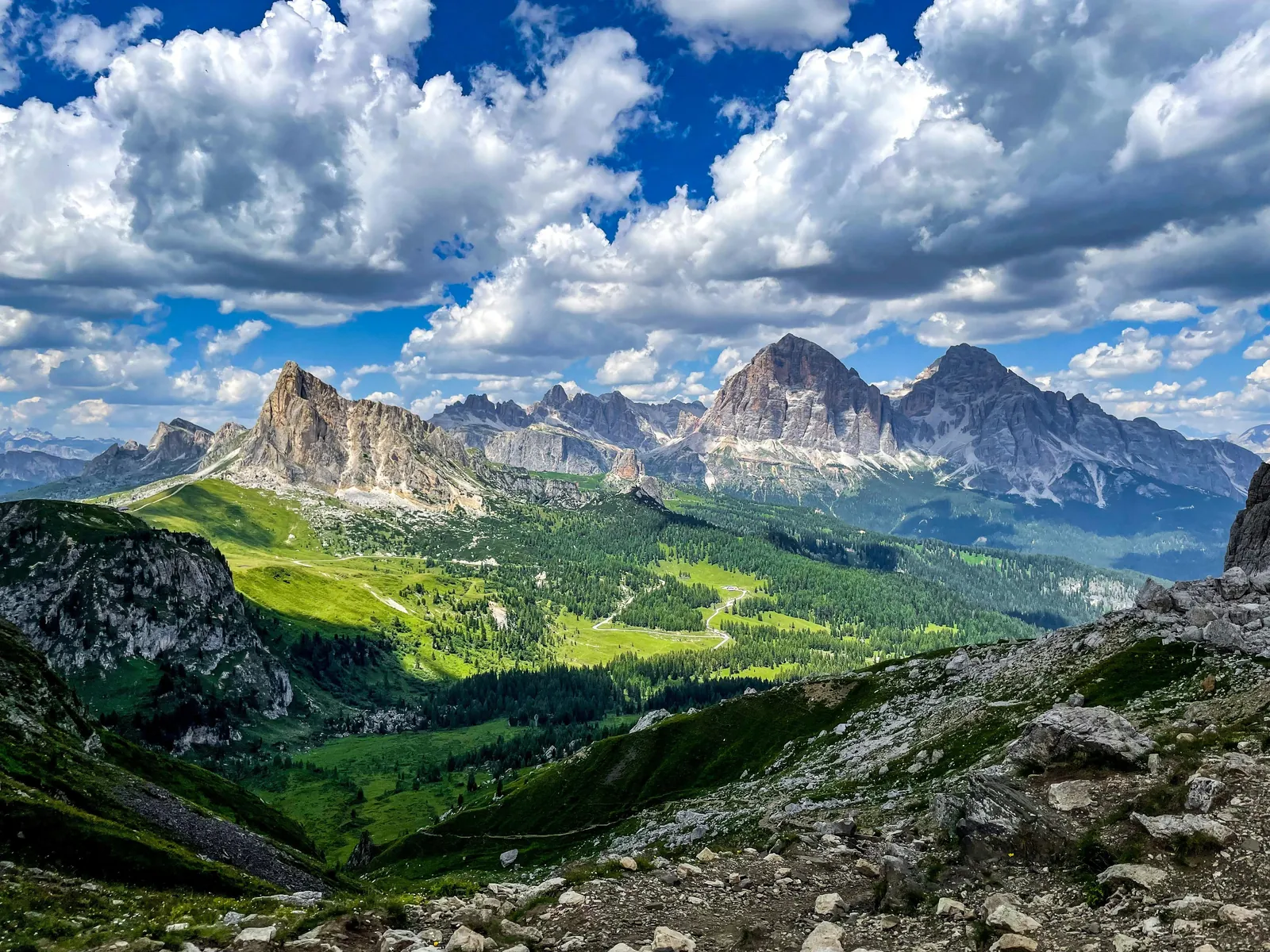 Road above Cortina d'Ampezzo with the Dolomites peaks under summer cloud