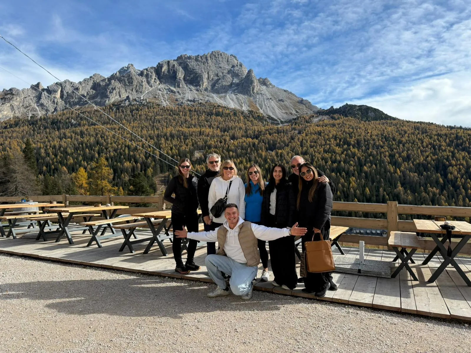 Tour group on a terrace below the peaks above Cortina