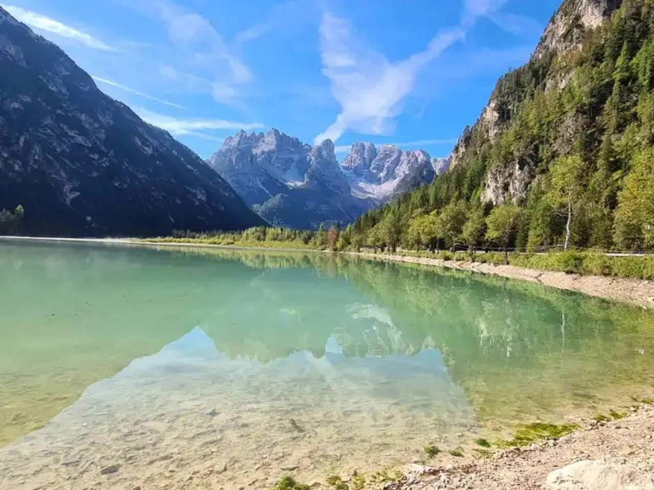 Clear green water of Lake Landro under the peaks